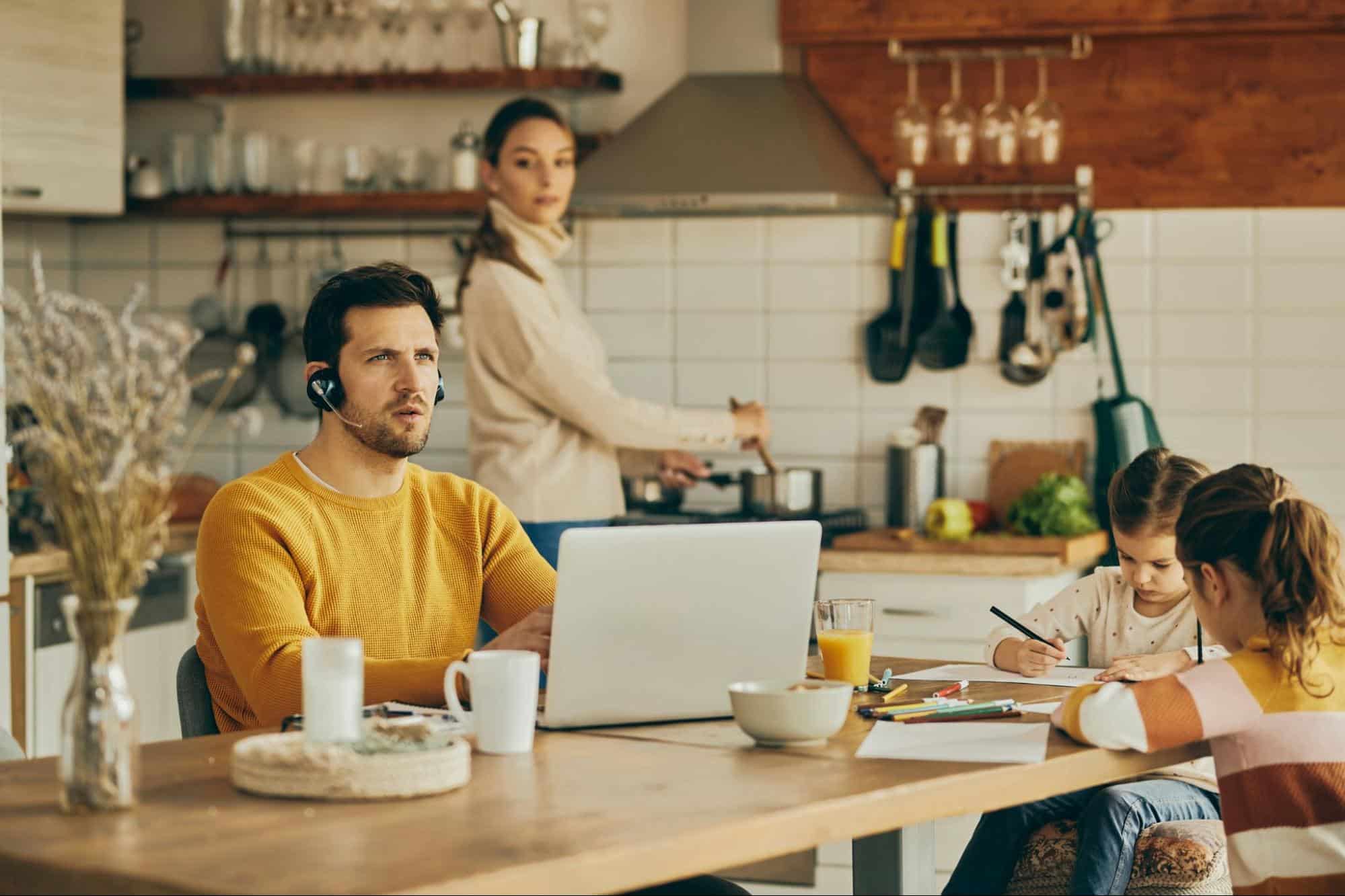 A man working while with his family