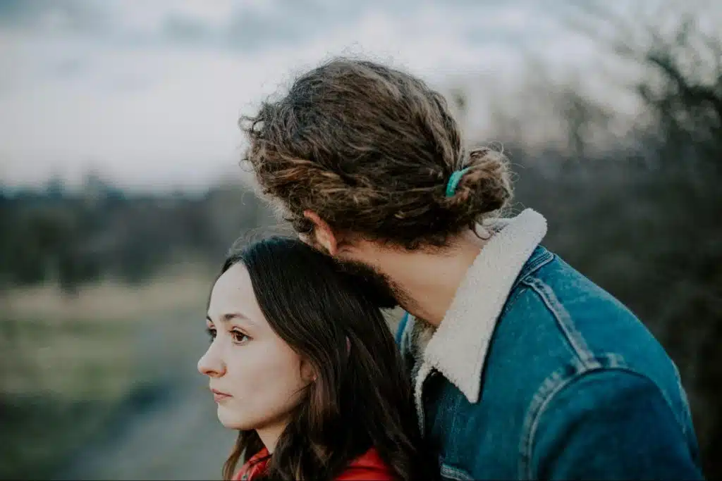 A man resting his head on woman’s head