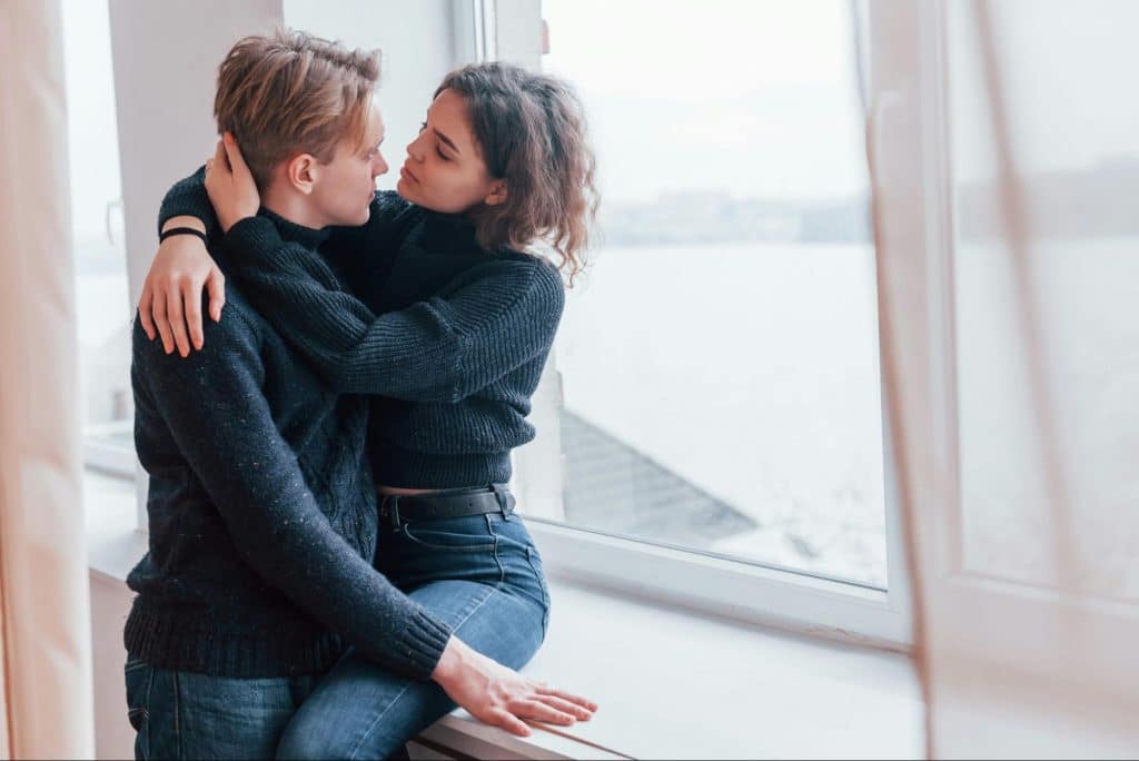 A man and woman embracing each other  
