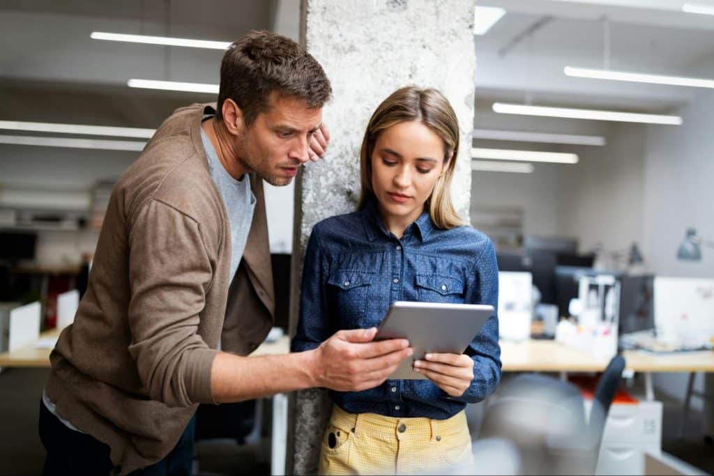 A woman distracted with her thoughts and a man checking her activity