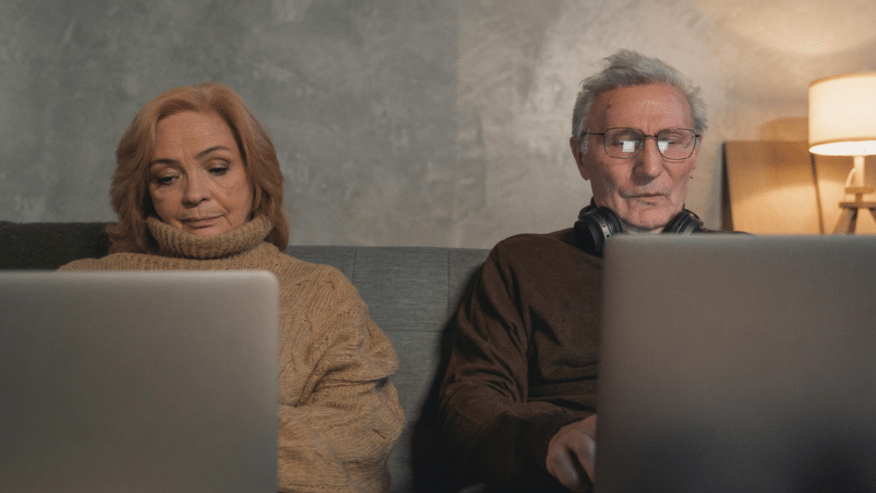 An elderly couple working from home