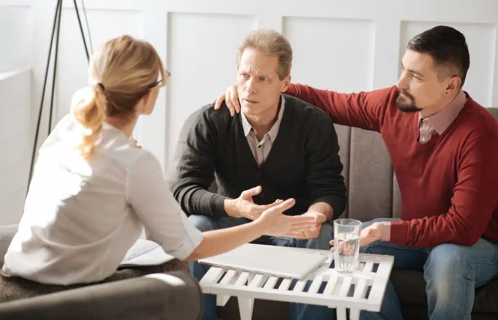 Three people talking.