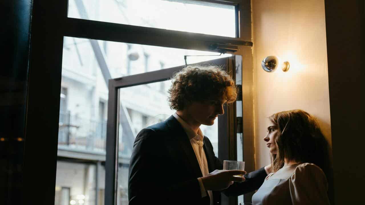 Couple talking quietly at a party