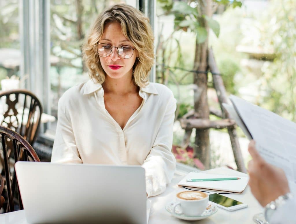 A businesswoman using a laptop in a café.