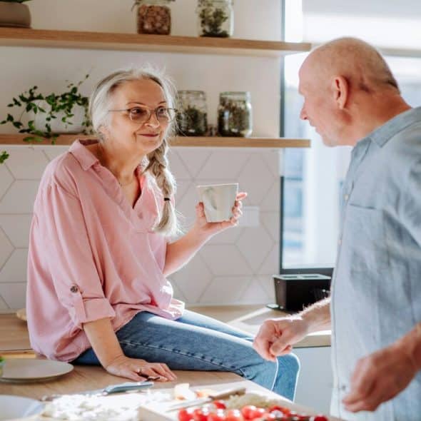 A couple talking in the kitchen
