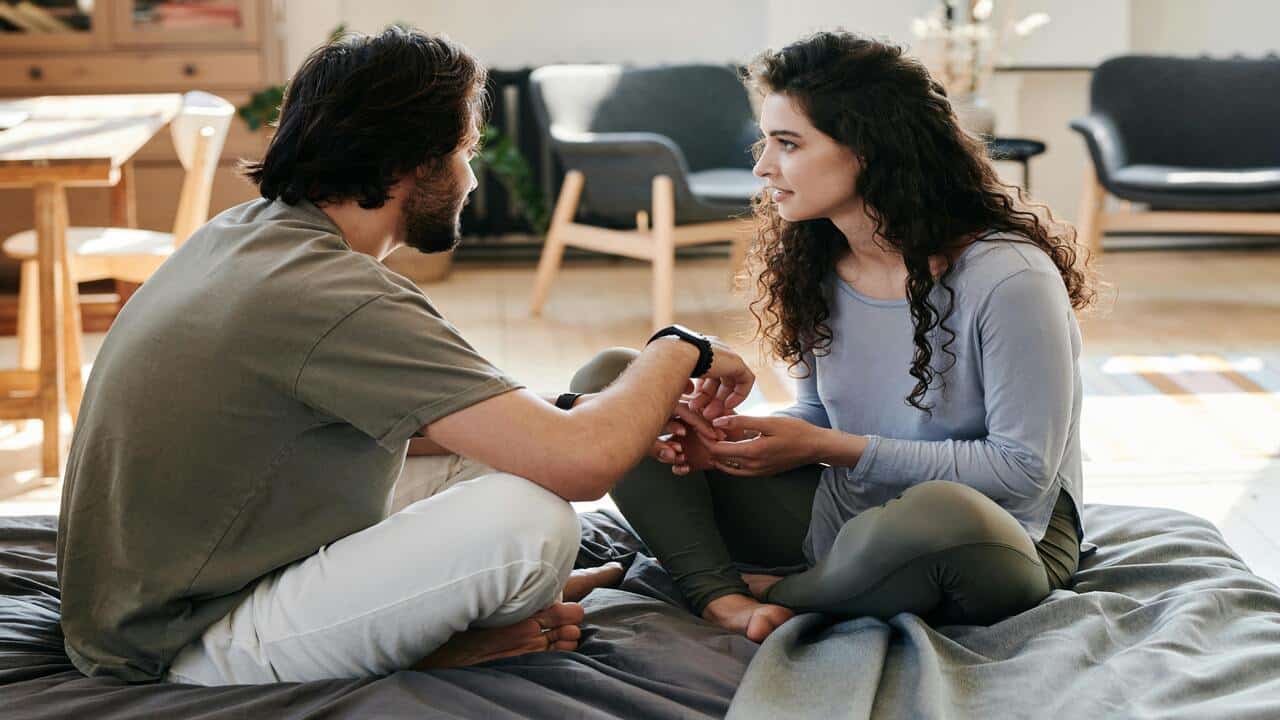 A couple talking in bed