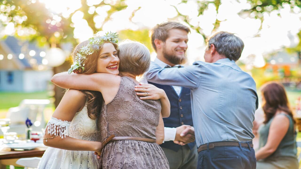 Parents greeting their kids at the latter’s wedding