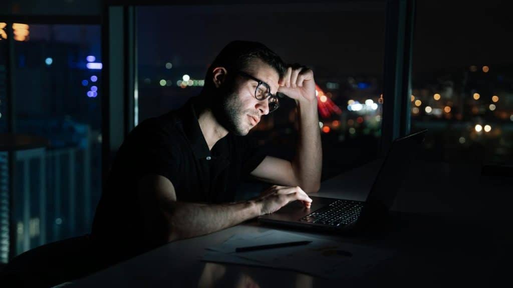 A person working late on a laptop at night.