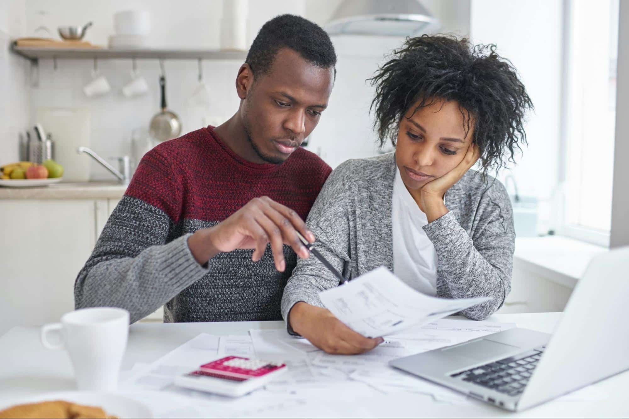 A man and woman checking their finances