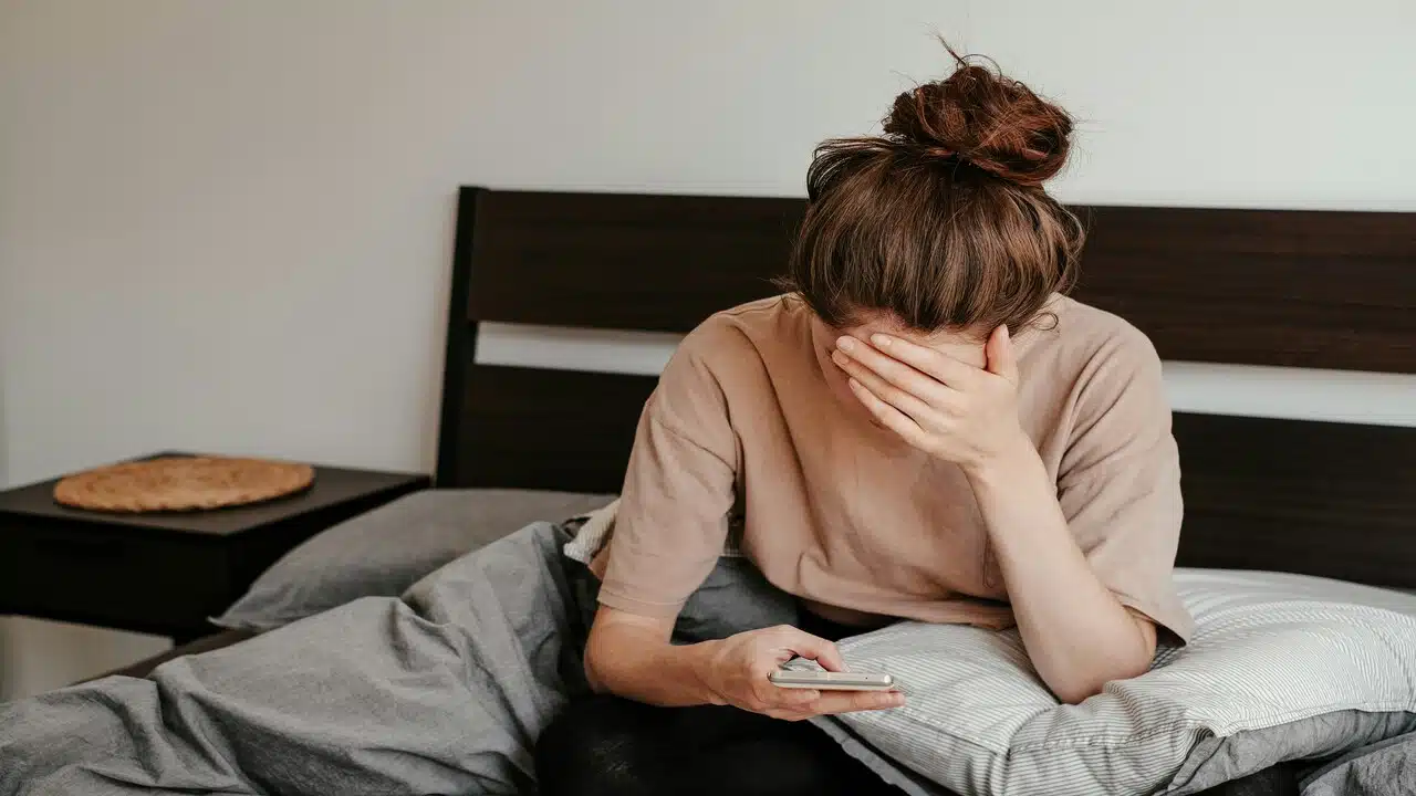 A woman looking sad while texting