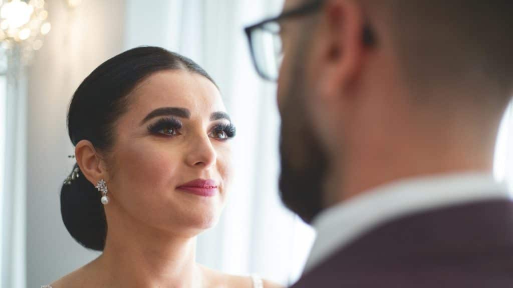 A beautiful woman looking at her husband.
