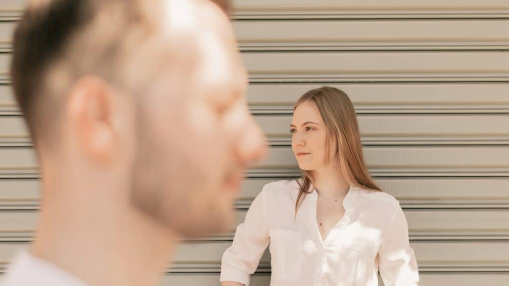 A man and a woman standing outdoors.