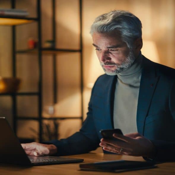 A businessman looking pensively at his laptop