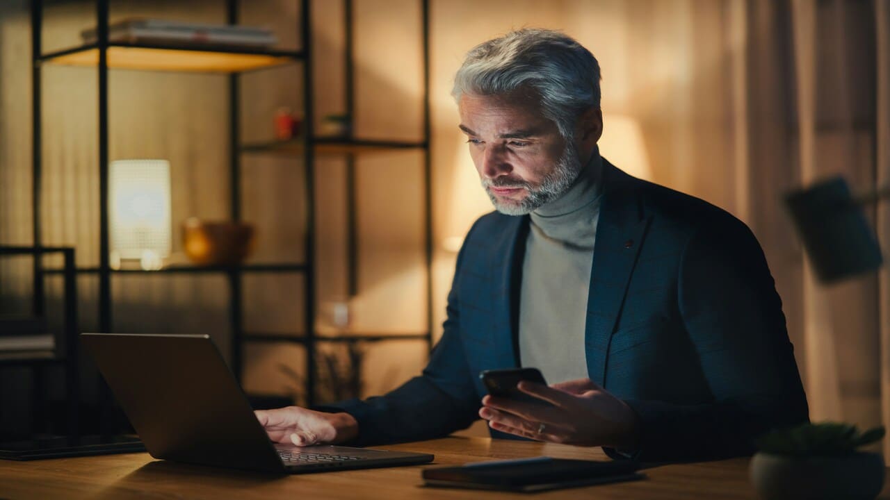 A businessman looking pensively at his laptop