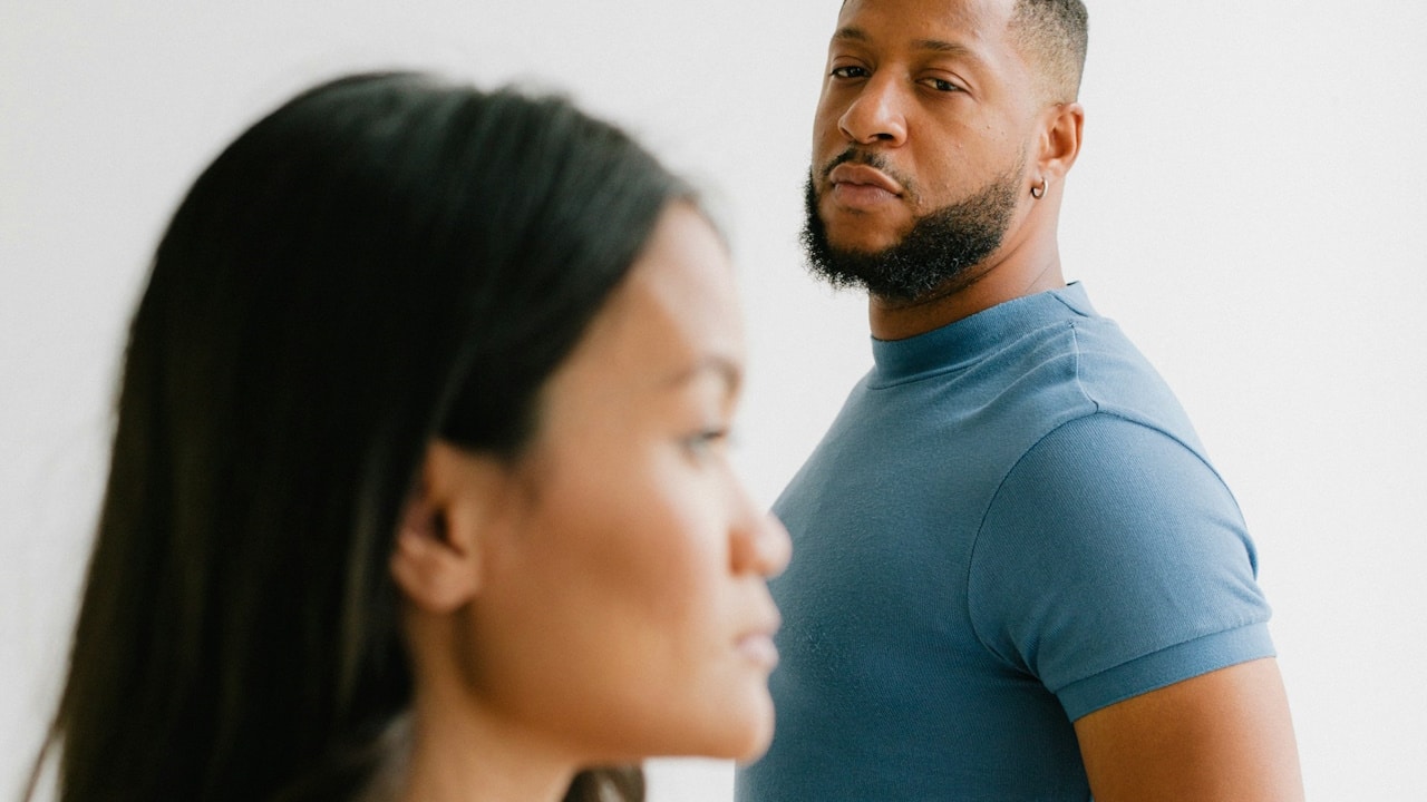 A bearded man looking at a woman.