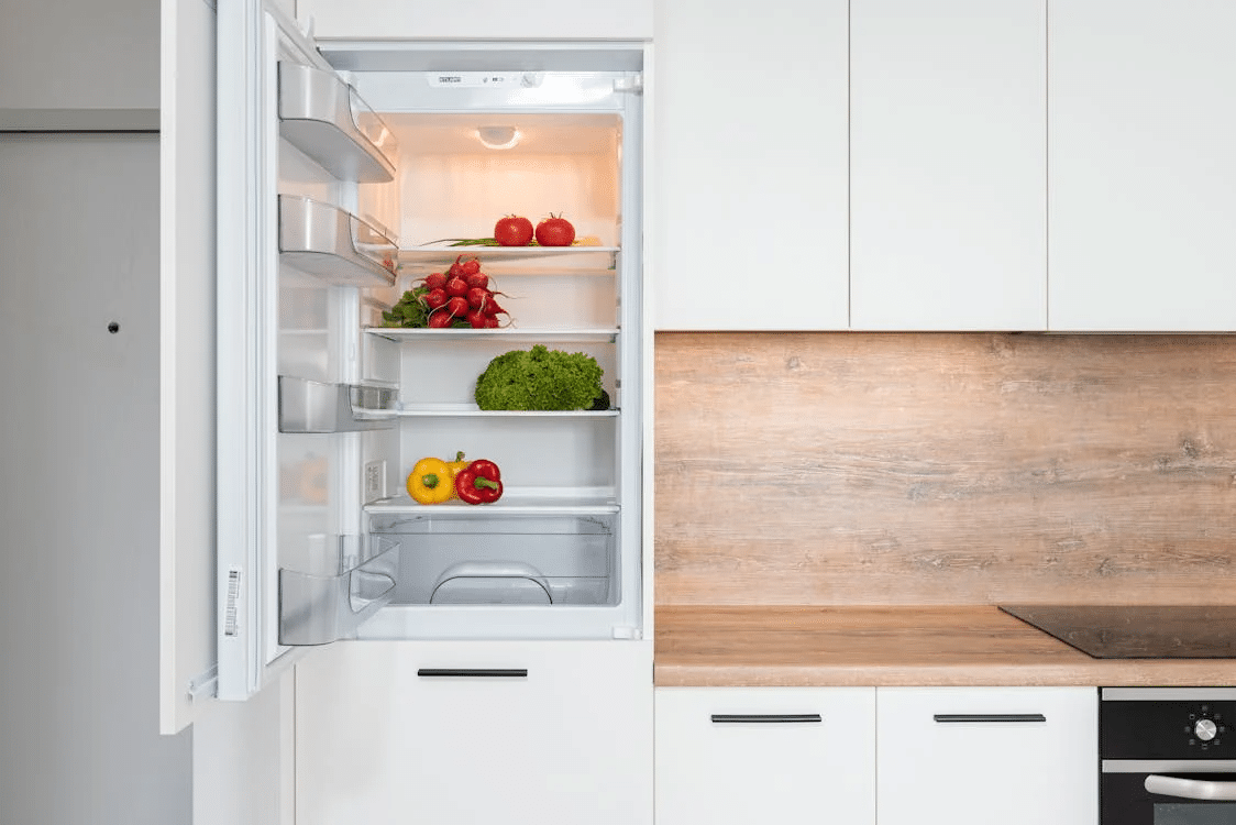 An open fridge with vegetables