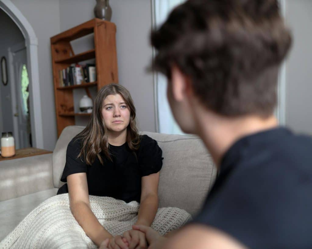 A sad woman in front of a man