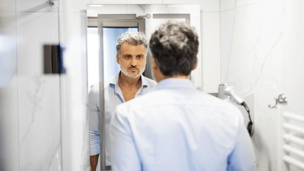 A man looking at himself in the mirror 