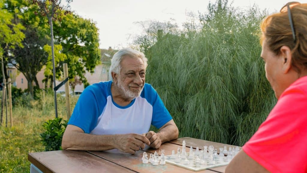 A man and woman playing chess indoors