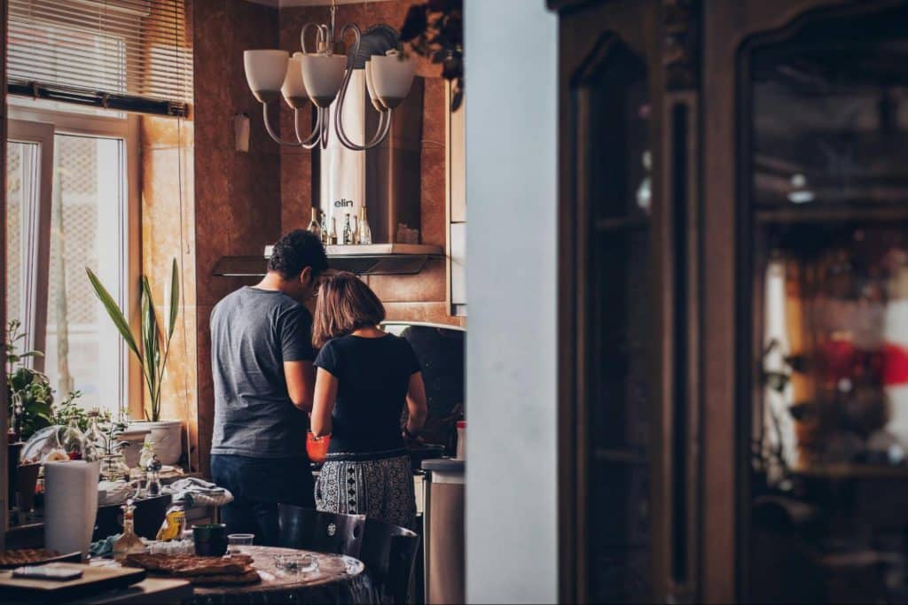 A man and woman at the kitchen