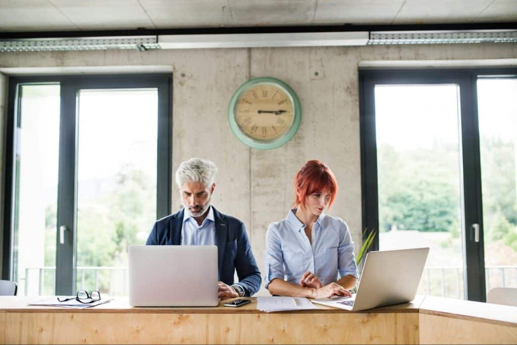 A man and woman working but not talking to each other