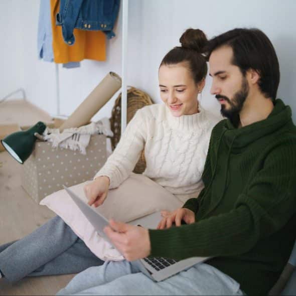 A man and woman sitting at the floor