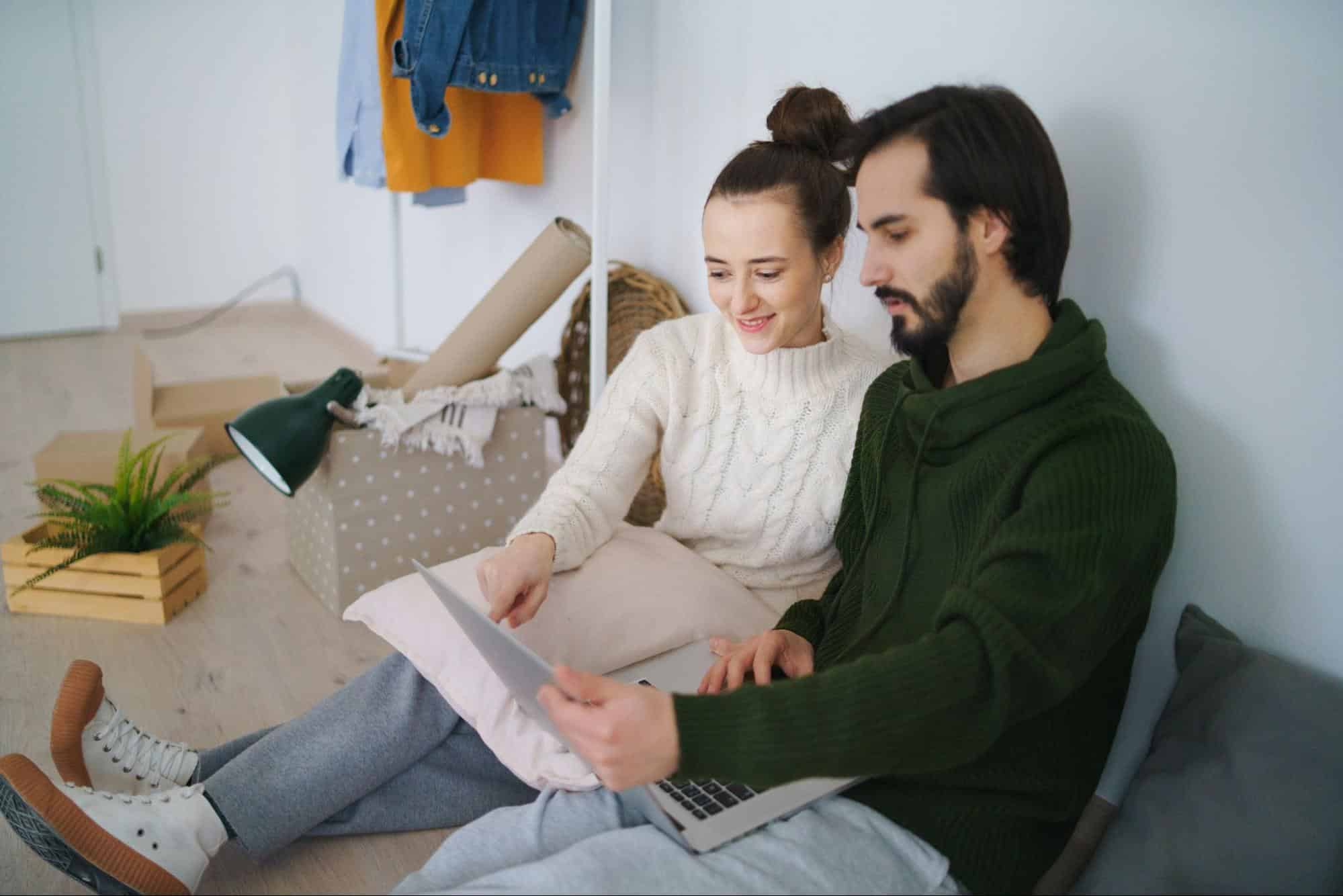 A man and woman sitting at the floor 