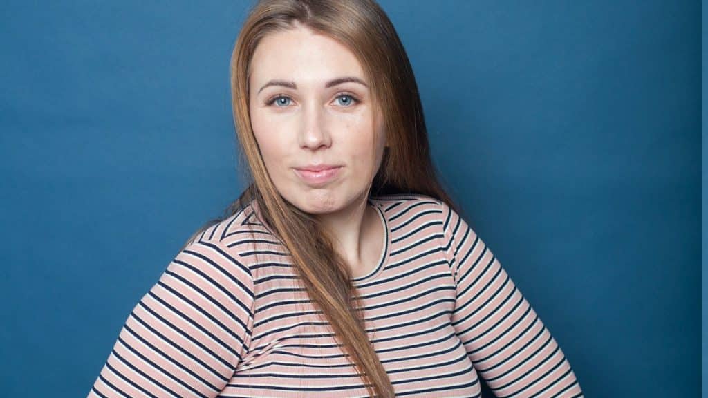 A bulky woman in a striped dress.