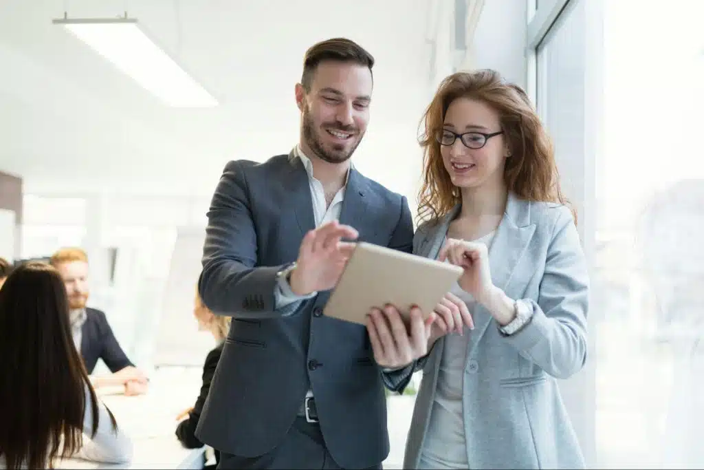 A man and woman looking at the tablet