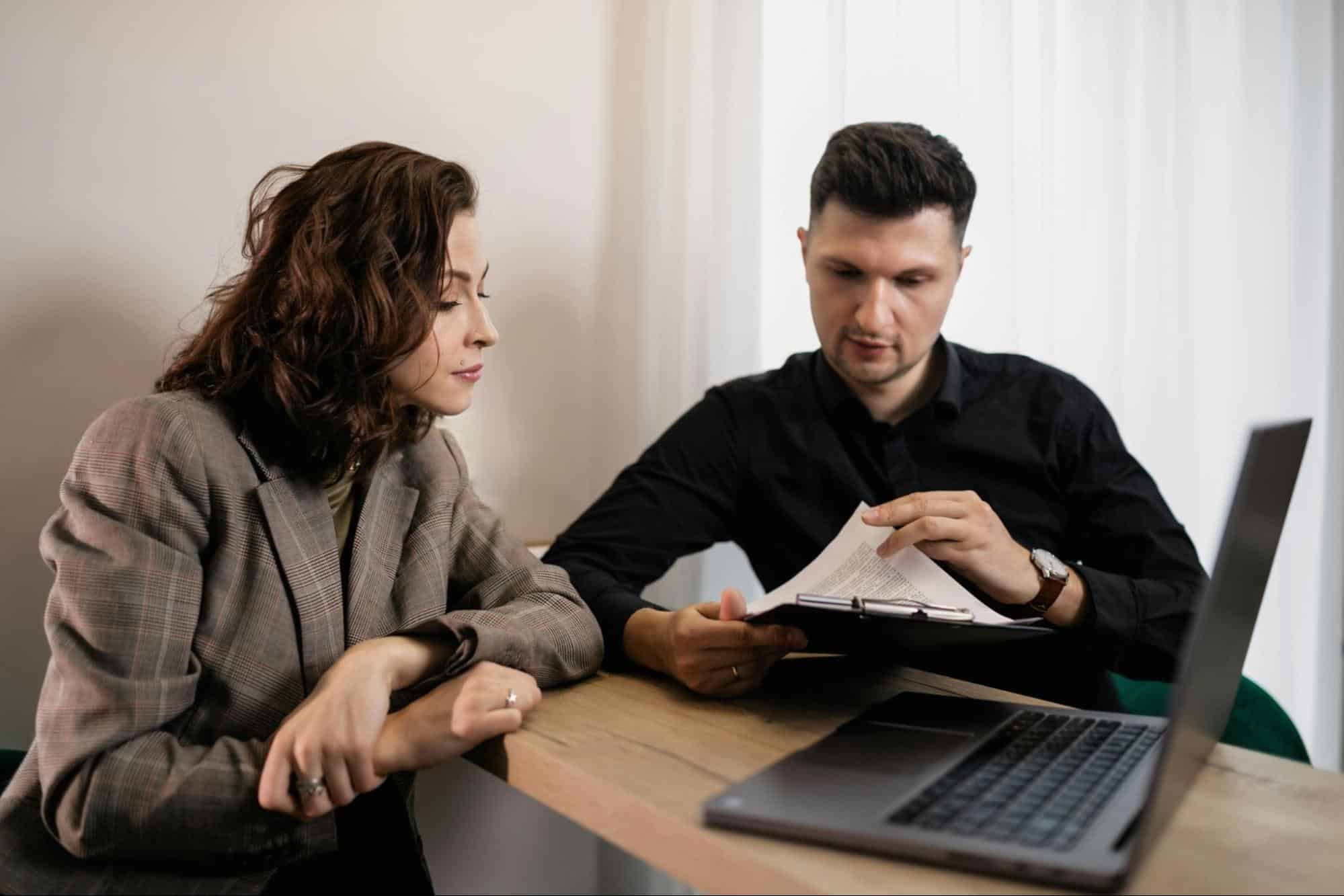 A man and woman busy with their documents
