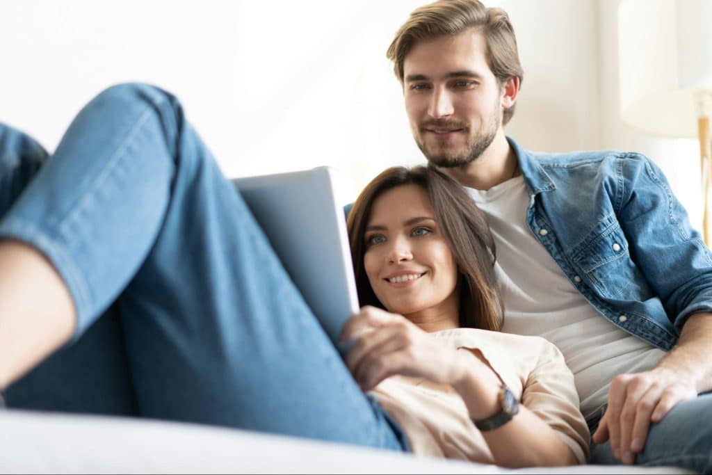 A man looking at the woman’s laptop