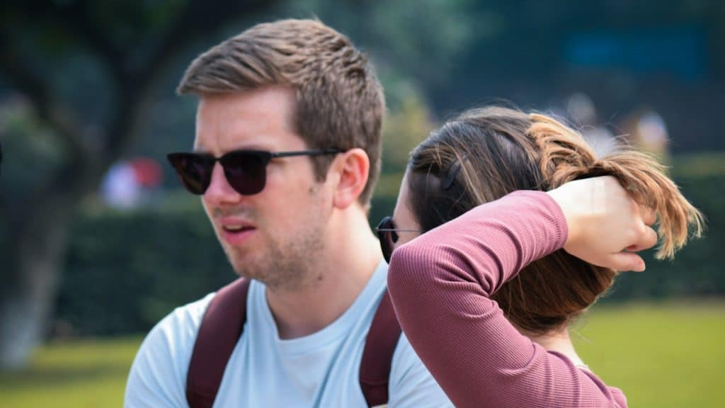 A man and a woman standing next to each other outdoors.