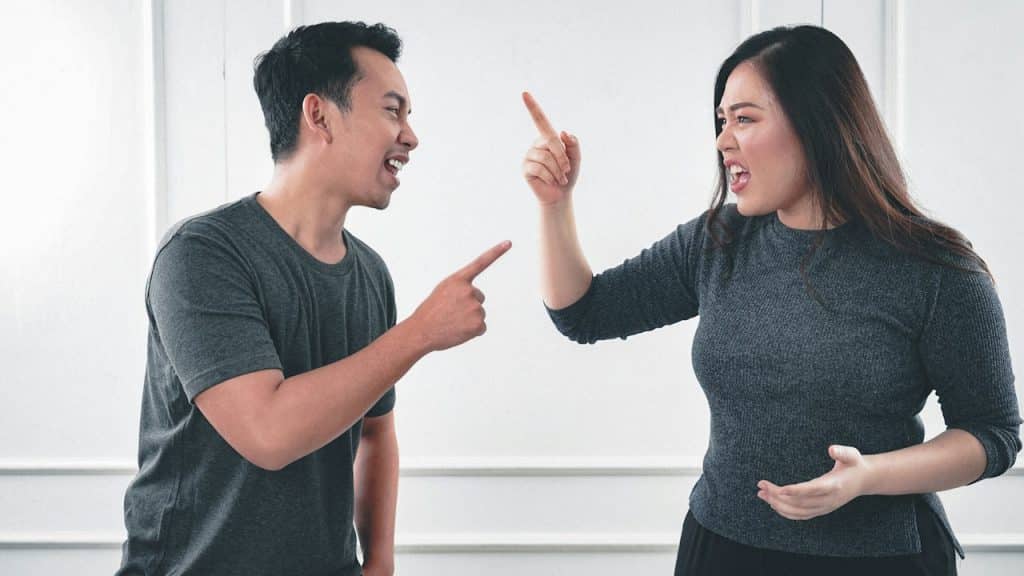 A man and a woman arguing with each other.