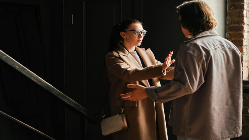 A couple fighting by the staircase