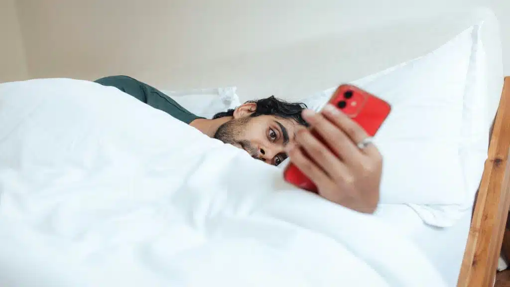 A man looking sadly at his phone