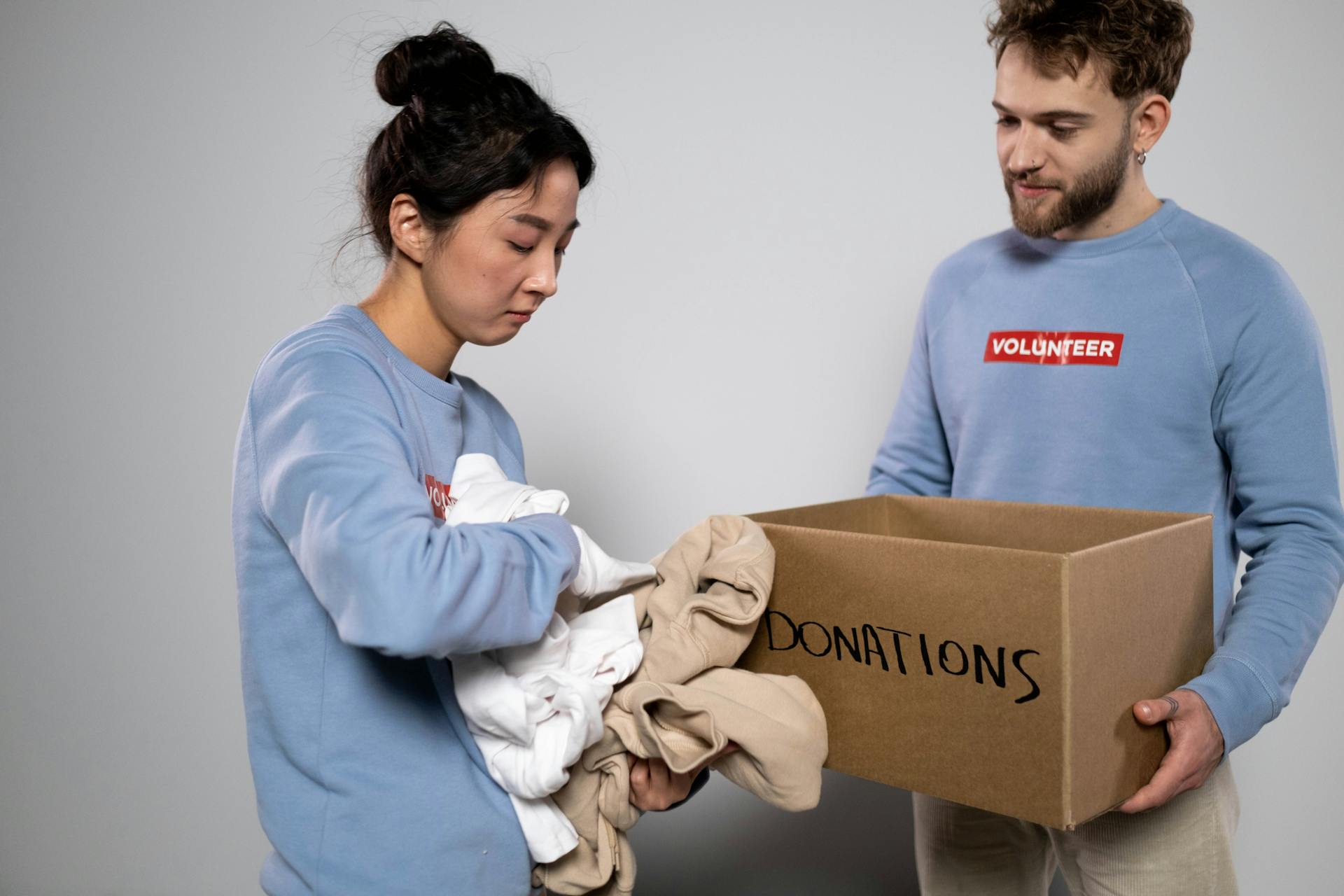 A woman holding clothes for donation.
