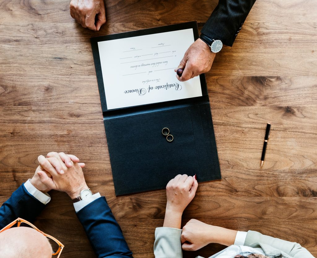 A person stamping a document that says “Certificate of Divorce.”