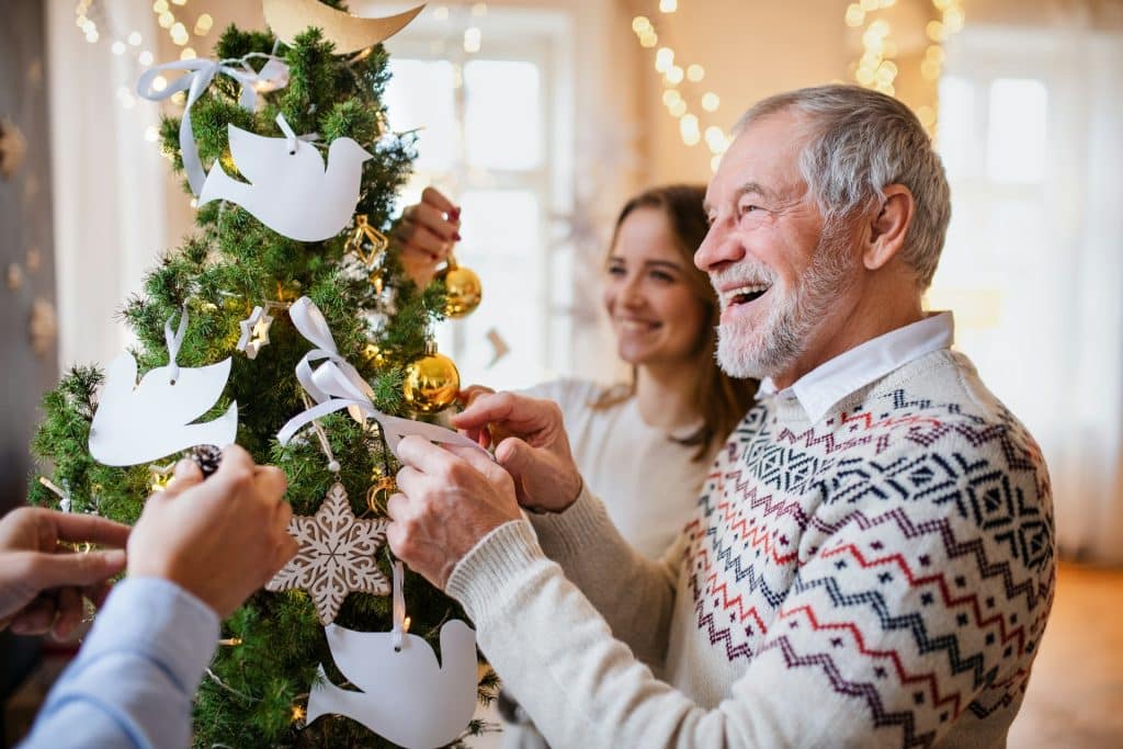 A family decorating a Christmas tree.