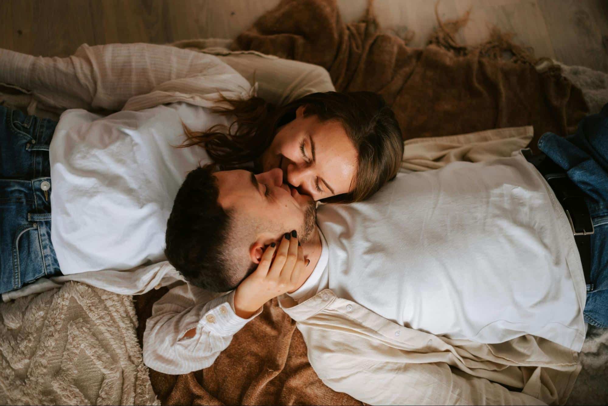 A man and woman laying on a bed 