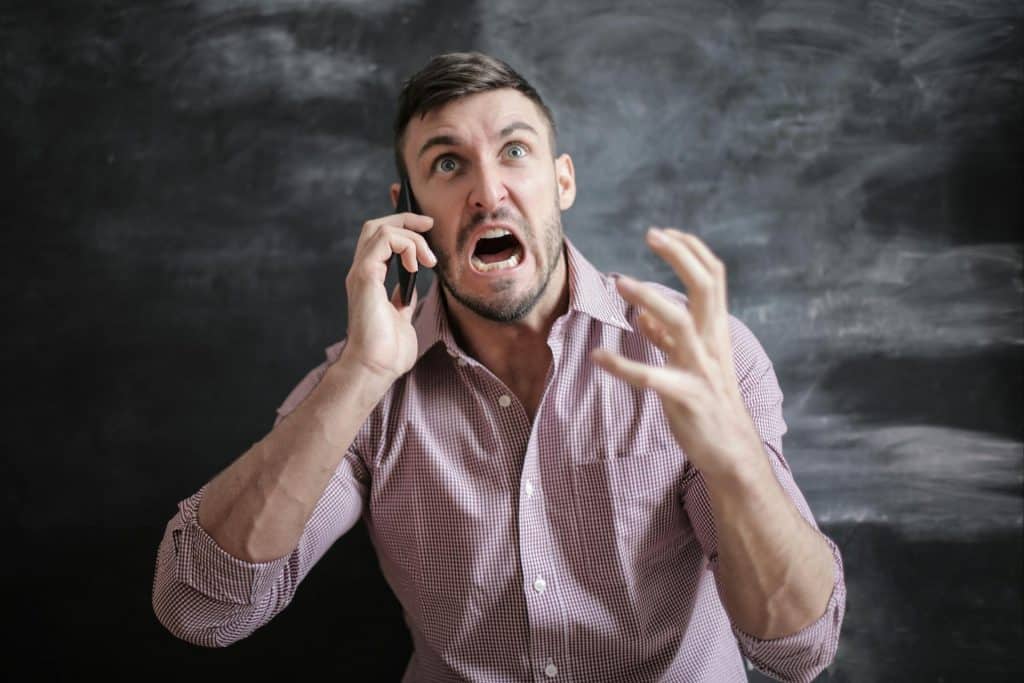 A man yelling at someone he’s talking to in a call.