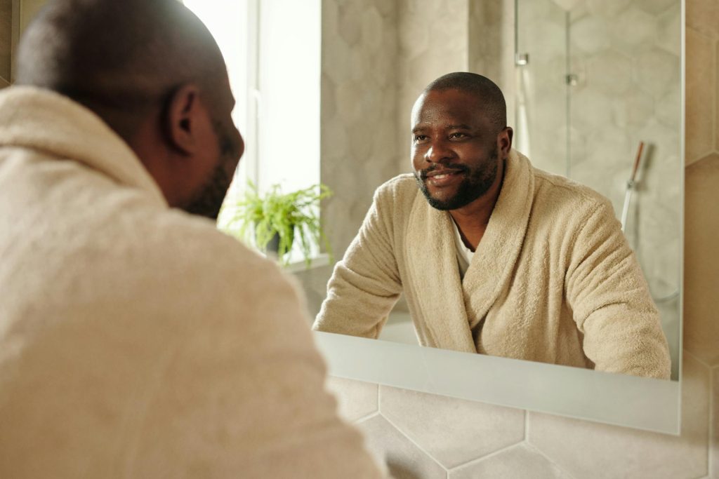 A man looking at the mirror.