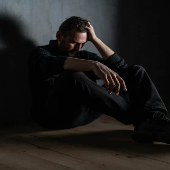 A man sitting alone in the dark