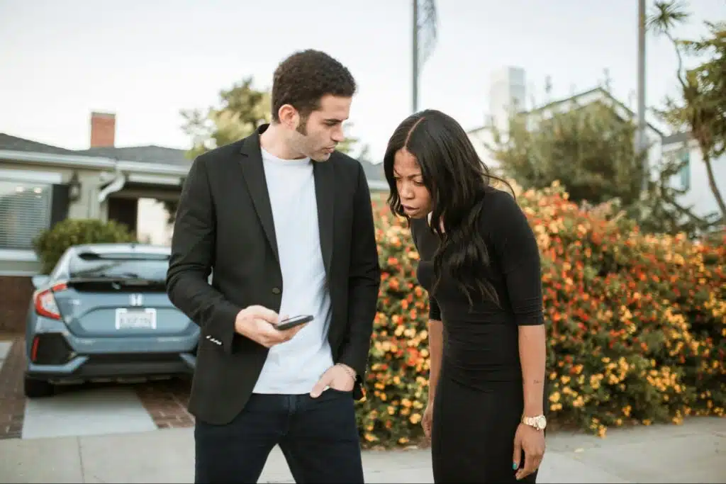 A man showing something to woman
