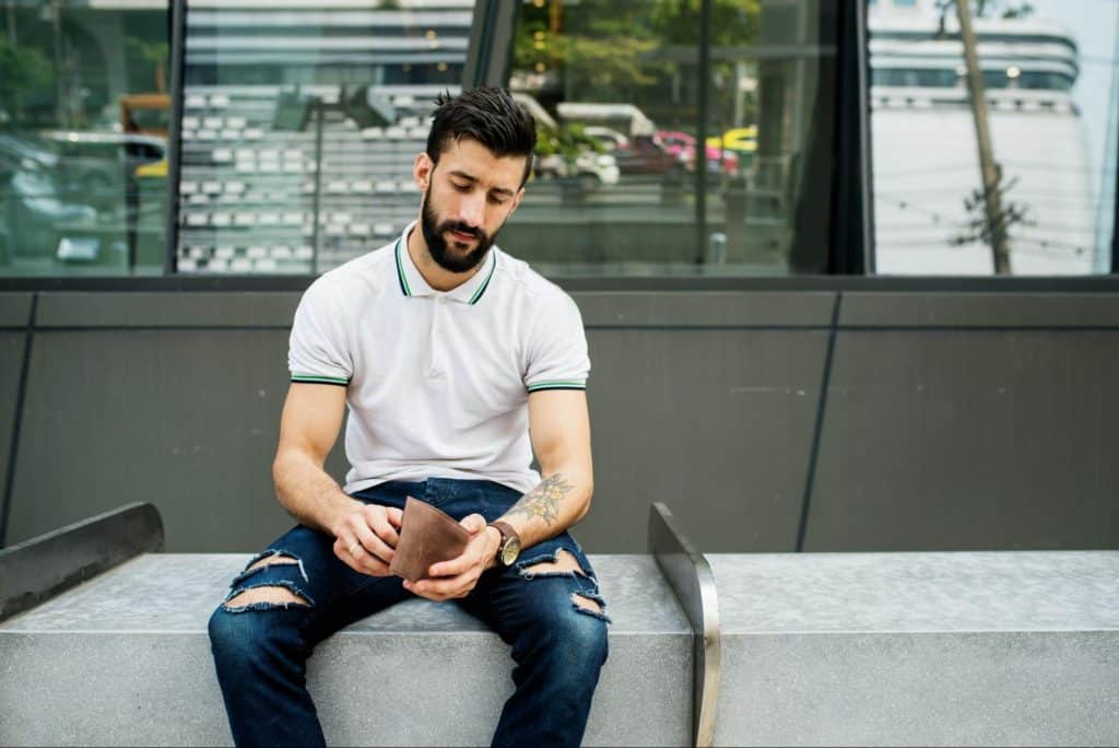 A man looking at his wallet