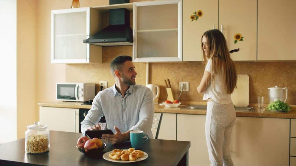 A man and woman at the kitchen
