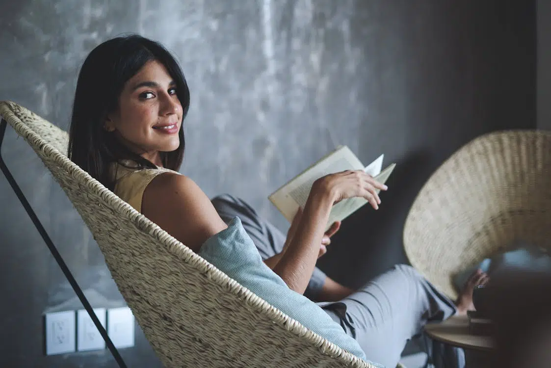 A woman smiling while holding a book