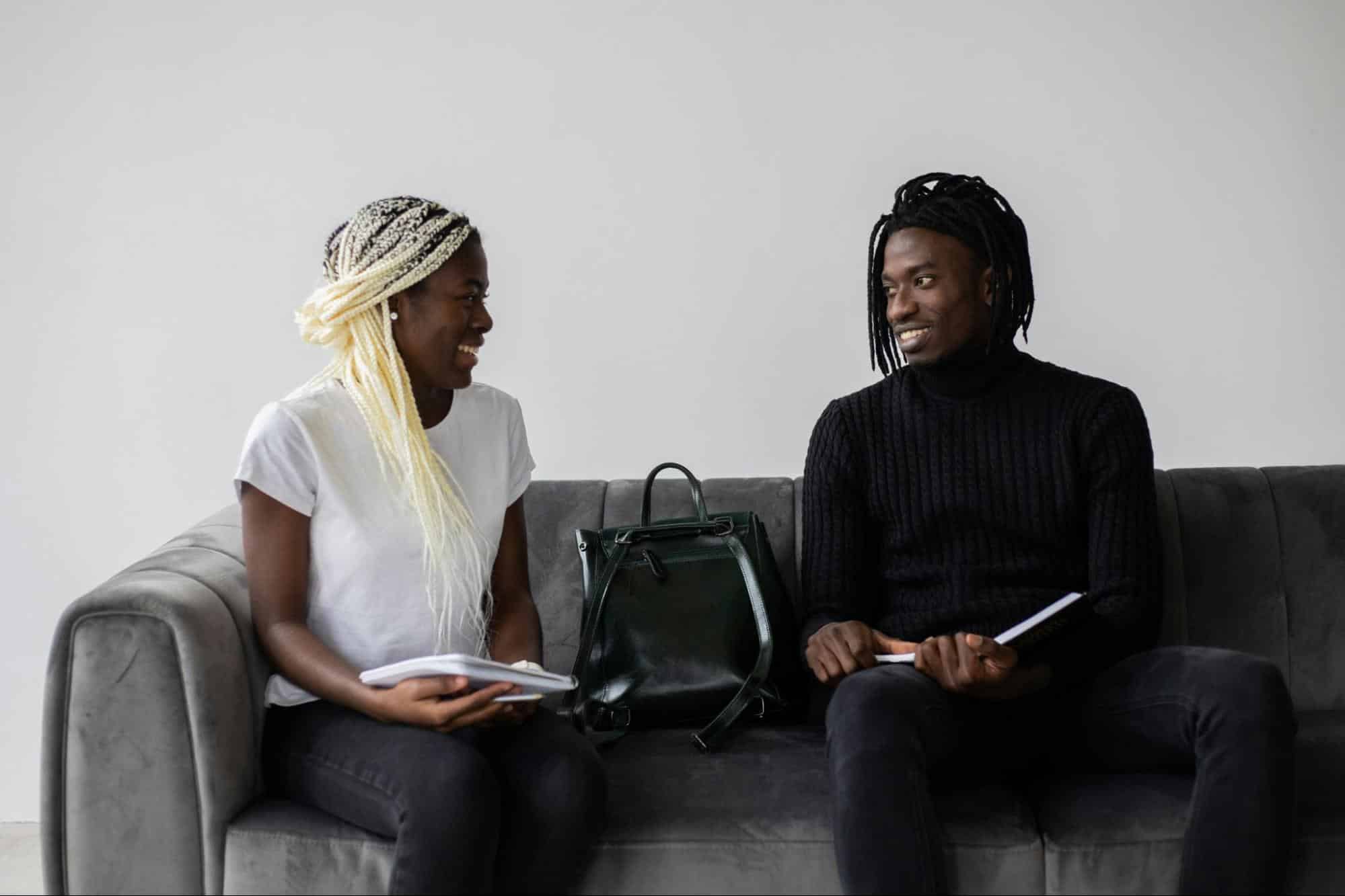 A man and woman sitting at the couch