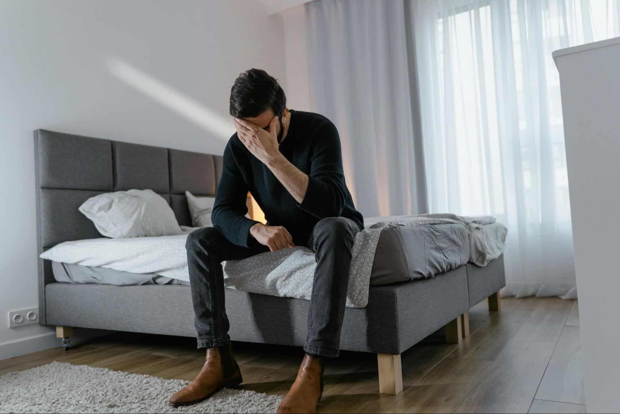 A man holding his head