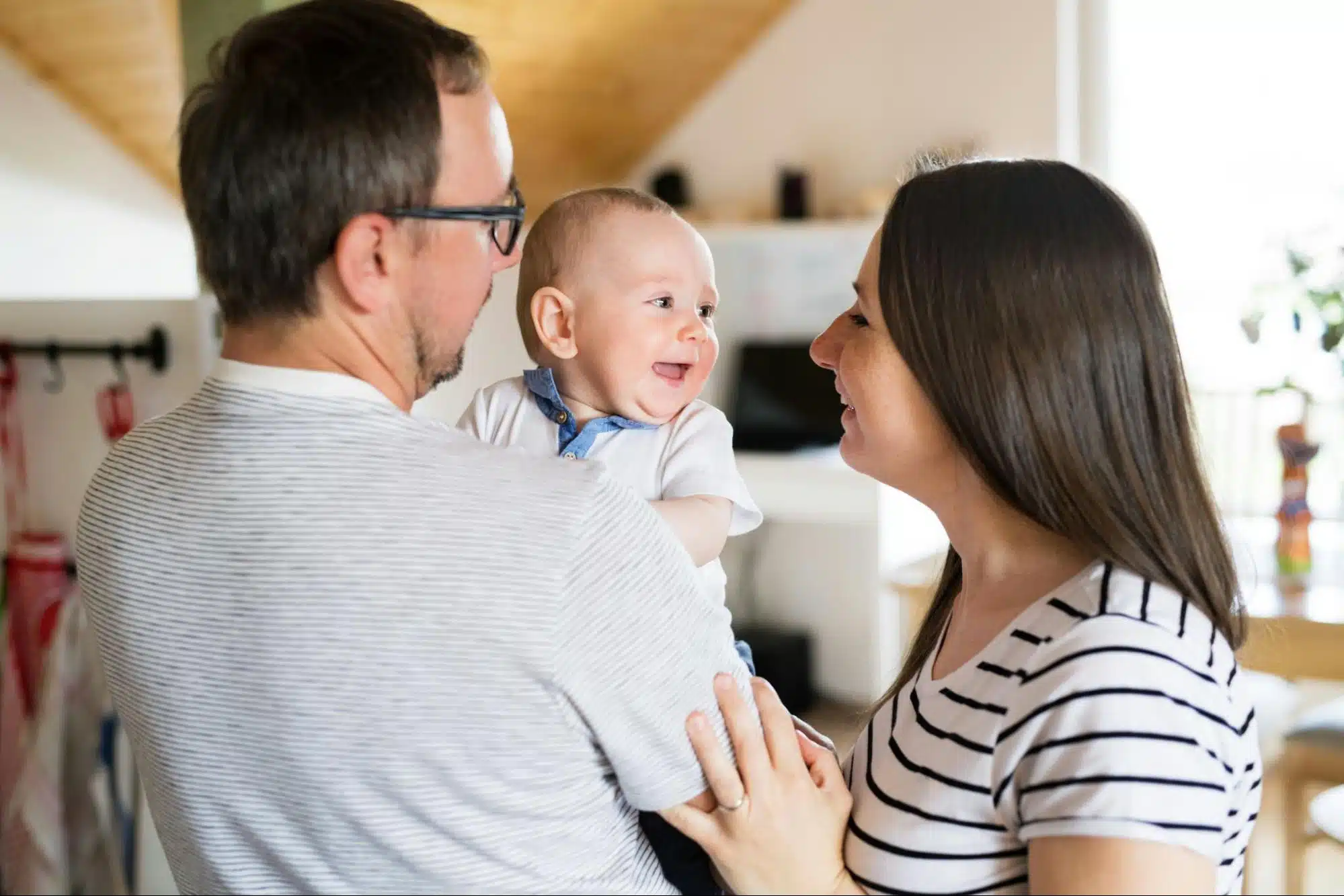 A man and woman holding a baby