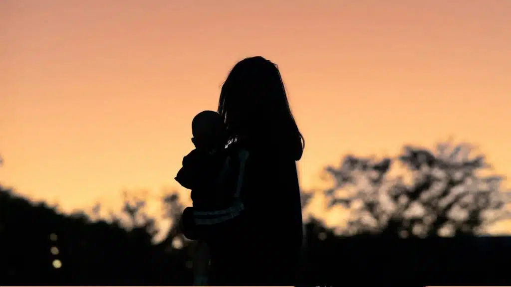 Silhouette of a person and child.